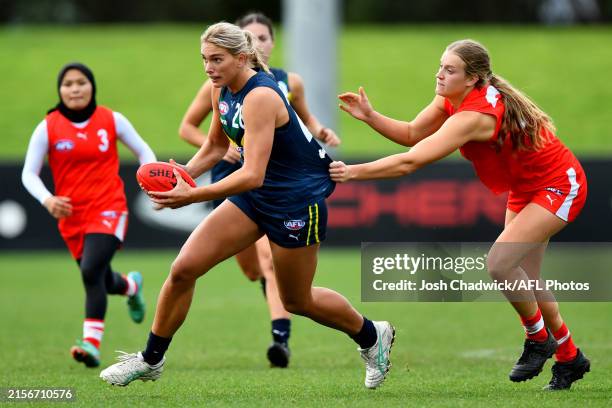 Havana Harris of Australia U18 is tackled by Alexis Gregor of the All-Stars during the Marsh AFL National Championships U18 Girls Australia v All...