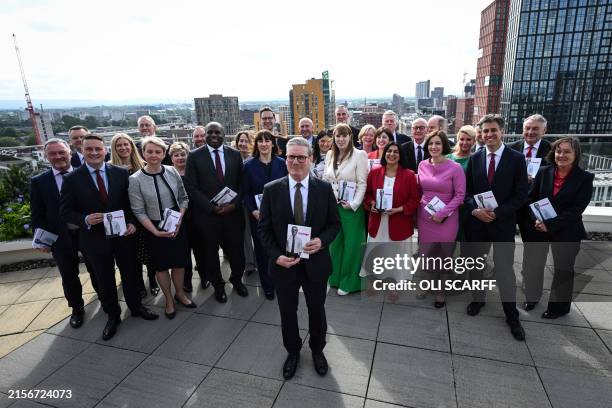 Britain's main opposition Labour Party leader Keir Starmer poses, among members of the party and members of the Britain's shadow cabinet, with the...