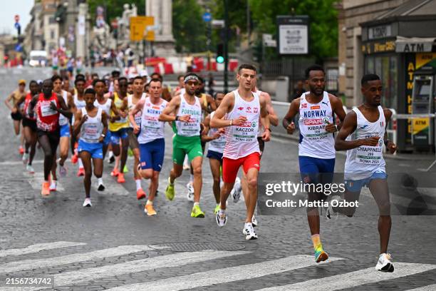 Yohanes Chiappinelli of Team Italy, Awet Nftalem Kibrab of Team Norway and Mateusz Kaczor of Team Poland leads the team out the field in the Men's...
