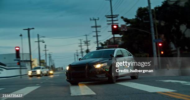 coche de policía girando en la calle del centro de los ángeles por la noche - coche de policía fotografías e imágenes de stock