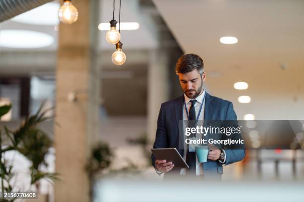 a businessman with a digital tablet - name badge person stock pictures, royalty-free photos & images