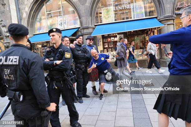 Scotland fan poses with police officers ahead of UEFA EURO 2024 on June 13, 2024 in Munich, Germany.