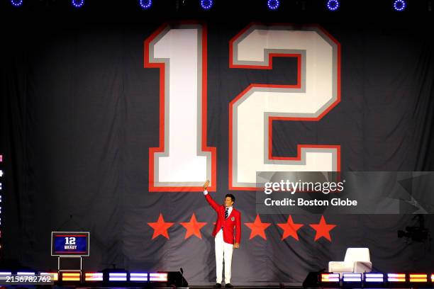Foxborough- Tom Brady, Former New England Patriots quarterback, waves under his retired number 12 on stage at Gillette Stadium after his induction...
