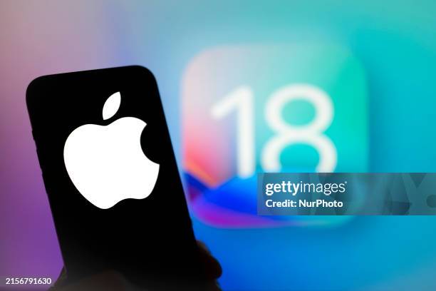The Apple logo is seen with the iOS 18 operating system logo in the background on a mobile device in this illustration photo taken in Warsaw, Poland...