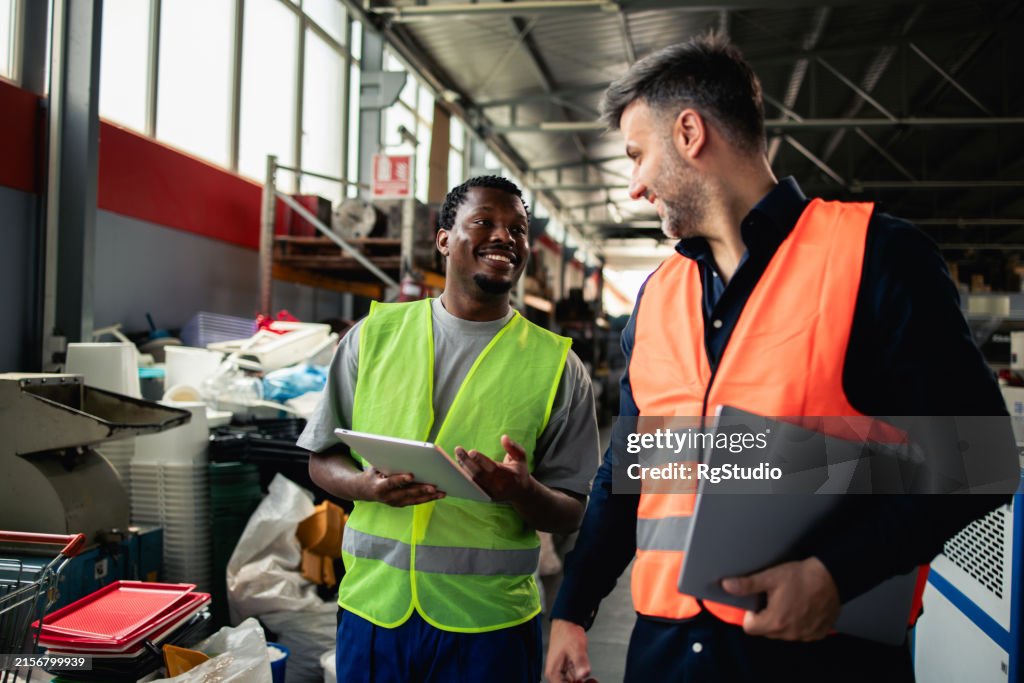 Two factory colleagues discussing the production strategy