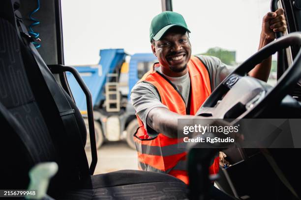 african american truck driver going to make a delivery to a warehouse - vrachtwagenchauffeur stockfoto's en -beelden