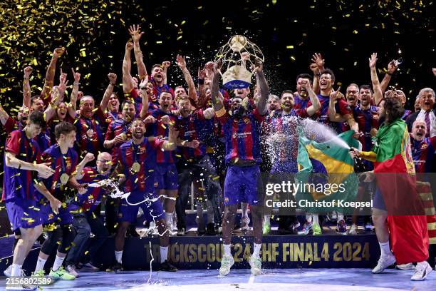 Dika Mem of Barcelona lifts the trophy on the podium after winning the EHF Final4 Men Champions League final match between Aalborg Handbold and FC...