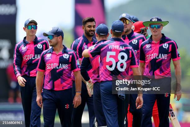 Players of Scotland celebrate a wicket during the ICC Men's T20 Cricket World Cup West Indies & USA 2024 match between Oman and Scotland at Sir...