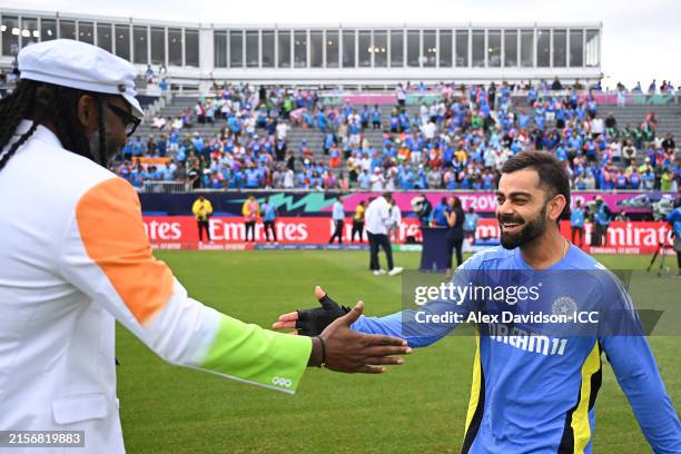 Virat Kohli of India interact with Former West Indies Cricketer Chris Gayle prior to the ICC Men's T20 Cricket World Cup West Indies & USA 2024 match...