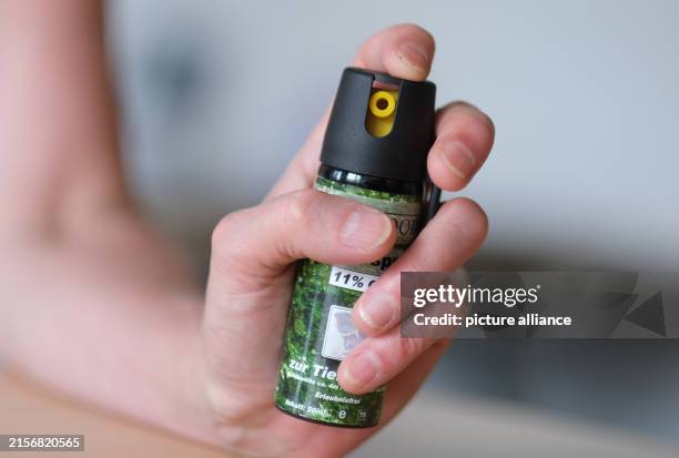 June 2024, Baden-Württemberg, Stuttgart: One hand holds a canister of pepper spray. Photo: Bernd Weißbrod/dpa