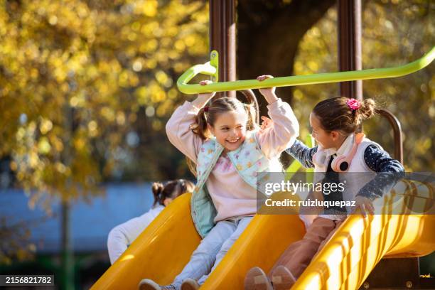 happy girls playing on the playground - 8 year old play stock pictures, royalty-free photos & images