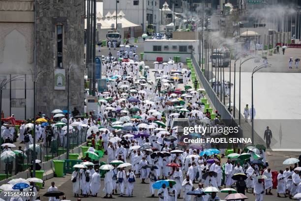 Muslim pilgrims arrive at the Mina tent camp during the annual Hajj pilgrimage near the holy city of Mecca on June 14, 2024. More than a million...