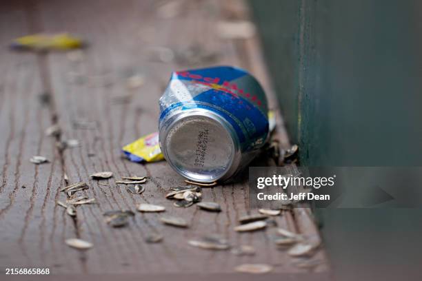 Can and sunflower seeds sit on the floor of the Chicago Cubs' dugout during a baseball game against the Cincinnati Reds at Great American Ball Park...