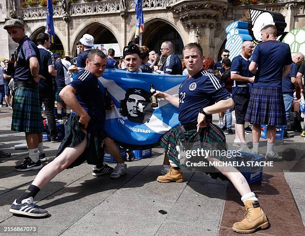 Supporters of Scotland's national soccer teamwearing kilts celebrate with beer and a flag at the central square Marienplatz ahead of the UEFA Euro...