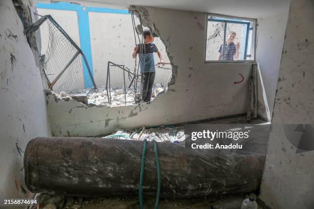 An unexploded ordnance is seen in a damaged UNRWA school, in which Palestinians took shelter after the building was hit during Israel's assaults, in...