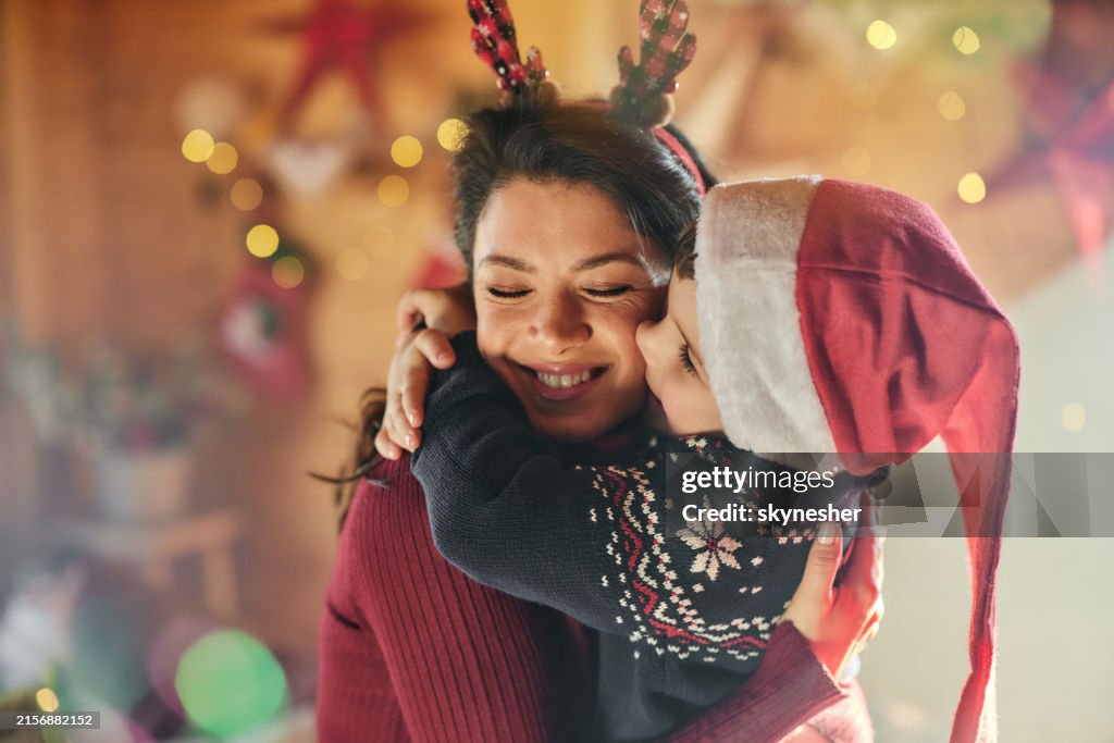 Happy mother enjoying with her son on New Year's day at home.