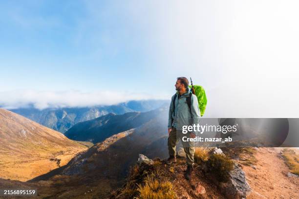 solo hiker enjoying a view after reaching top - alternative pose stock pictures, royalty-free photos & images