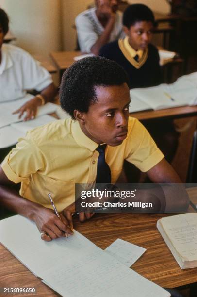 Student writing notes at a private school in Johannesburg, South Africa, circa 1988.