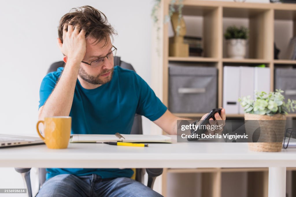 Man having work related issues using phone