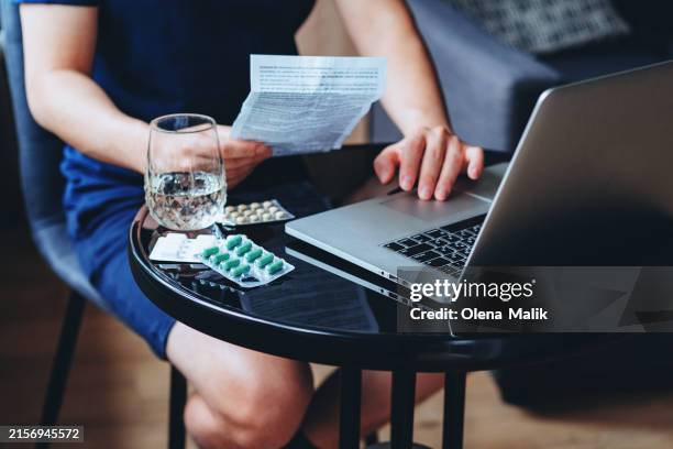 young man looking for information about medication online - nebenwirkungen von medikamenten stock-fotos und bilder