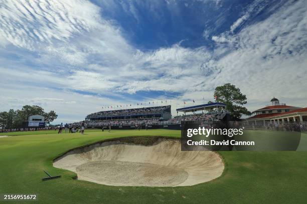 Tiger Woods of The United States and his playing partners Jordan Spieth, Justin Thomas and Rickie Fowler on the 18th green during practice prior to...