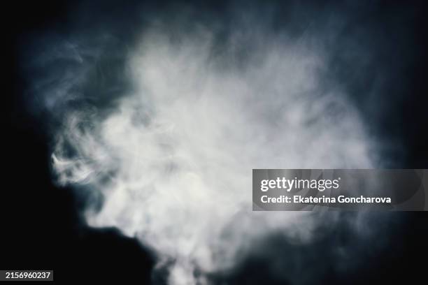 thick white smoke on a black background - fumo imagens e fotografias de stock