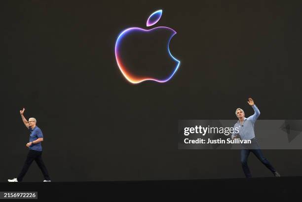 Apple CEO Tim Cook and Apple senior vice president of software engineering Craig Federighi greet attendees at the start of the Apple Worldwide...