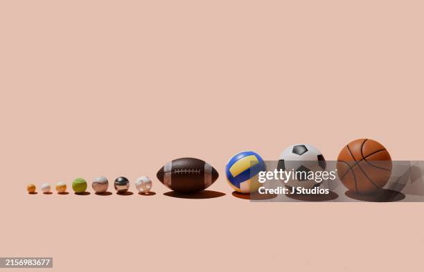 various sports balls in a row - american football ball stock pictures, royalty-free photos & images