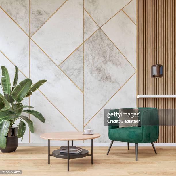 modern luxury interior: a living room with a soft green velvet armchair, low coffee table, marble white, golden and hardwood paneled wall background and decoration - square tile wall stock pictures, royalty-free photos & images