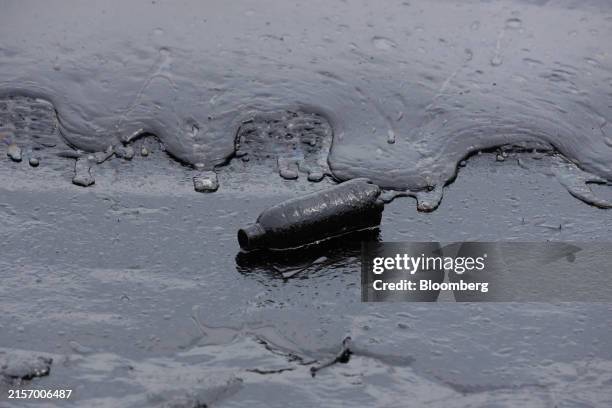 Oil coated sand and water along the Tanjong beach on Sentosa Island, Singapore, on Saturday, June 15, 2024. Singapore's port authorities are dealing...