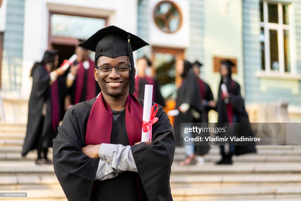 An alumnus holding his degree