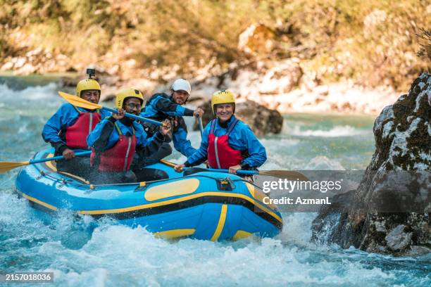 diverse team of mature rafters on guided river adventure - white water rafting stock pictures, royalty-free photos & images