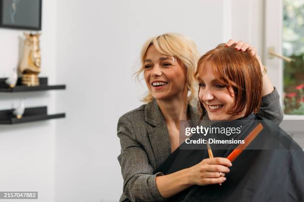 hairdresser smiling with her client - frisör bildbanksfoton och bilder