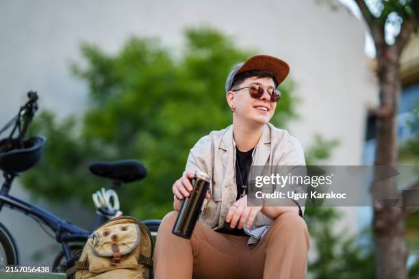 young woman resting next to river, with thermos - drinks flask stock pictures, royalty-free photos & images