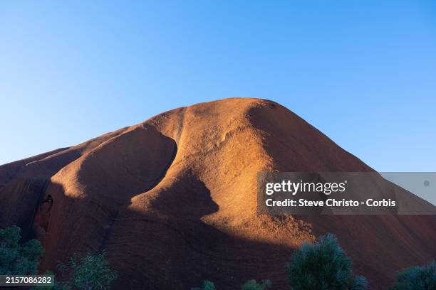 Last of the afternoon sun. Uluru, also known as Ayres Rock is sacred to the Pitjantjatjara the Aboriginal people of the area, known as the Anangu it...