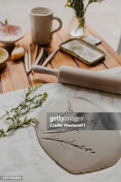 clay with imprint of flowers on table at home - rolling pin stock pictures, royalty-free photos & images