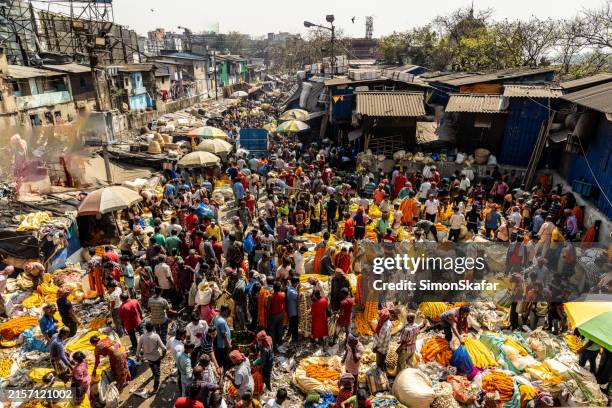group of people in flower market amidst kolkata city in india - kolkata stock pictures, royalty-free photos & images