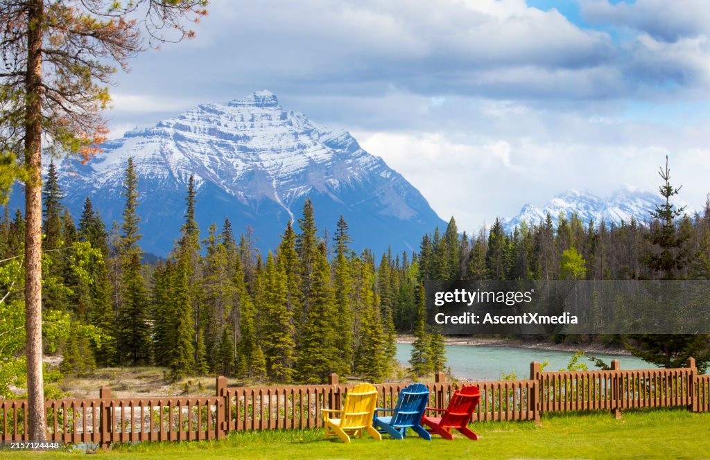 Scenic view of colourful chairs along a mountain river