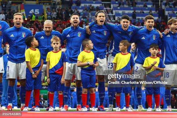 The mascots look up as the Italy players sing their national anthem enthusiastically during the UEFA EURO 2024 group stage match between Italy and...