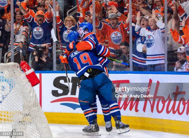 Adam Henrique of the Edmonton Oilers celebrates his first-period goal against the Florida Panthers with Mattias Janmark in Game Four of the 2024...
