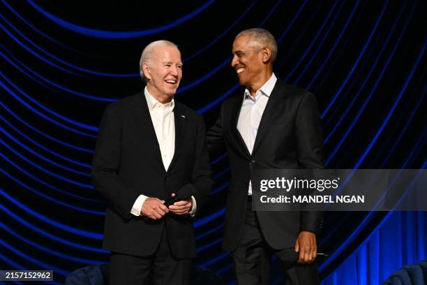 President Joe Biden stands with former US President Barack Obama onstage during a campaign fundraiser at the Peacock Theater in Los Angeles on June...