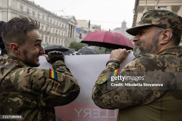 Ukrainian soldiers wearing LGBT and military badges as they participate in the Kyiv Pride parade on June 16, 2024 in Kyiv, Ukraine. This year marked...