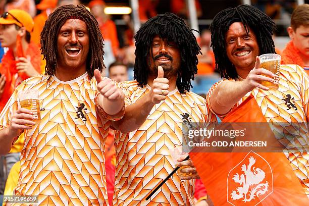 Dutch supporters wear wigs in tribute to former Dutch player Ruud Gullit ahead of the UEFA Euro 2024 Group D football match between Poland and the...