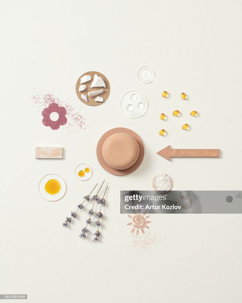 Beige round solid shampoo with natural ingredients. Soap with lavender. Circular composition of dry shampoo ingredients. Hair care products. Advertising. White background. Copy space