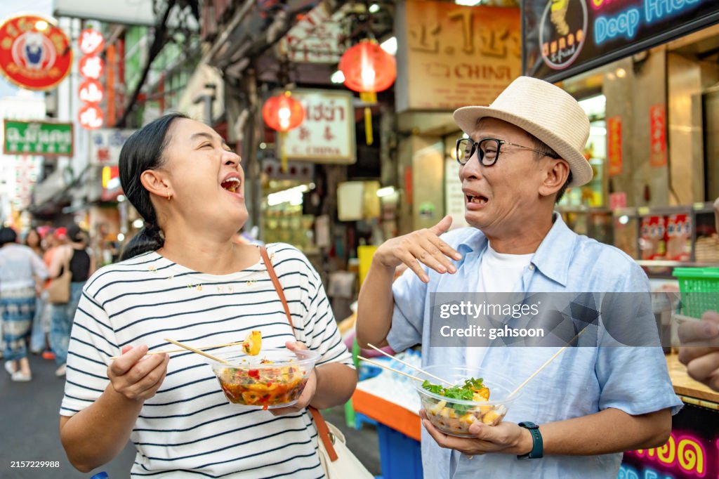 Tourist eating spicy street food at roadside