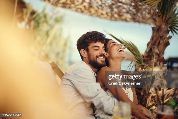 young cheerful couple embracing in summer day. - beach holiday stock pictures, royalty-free photos & images