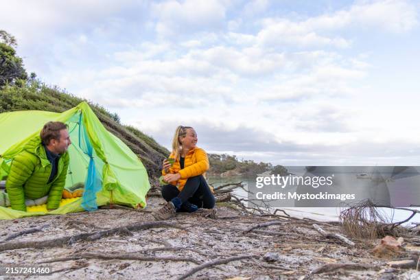 friends enjoying morning by the sea - friendly beaches tasmania stock pictures, royalty-free photos & images