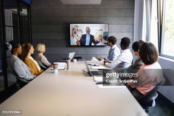 multiracial group of business people having a video conference with an male ceo - zoom tv stock pictures, royalty-free photos & images