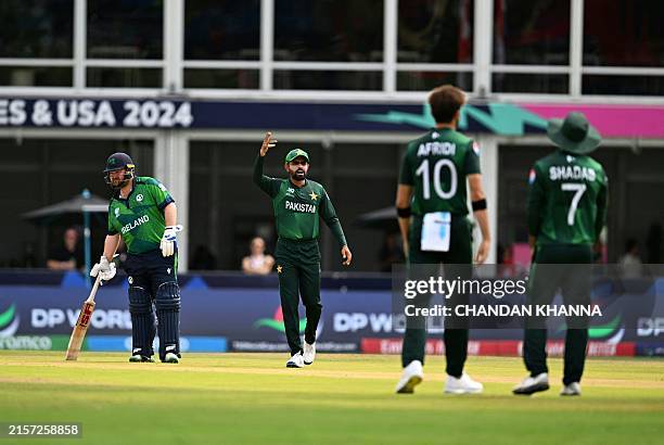 Pakistan's Shaheen Shah Afridi discusses with teamates after challenging the decision of the empire during the ICC men's Twenty20 World Cup 2024...