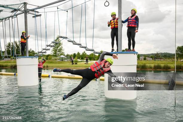 Leader of the Liberal Democrats Ed Davey falls into the water during a visit to the Spot-On Wake aqua jungle at Wootton Park on June 12, 2024 in...